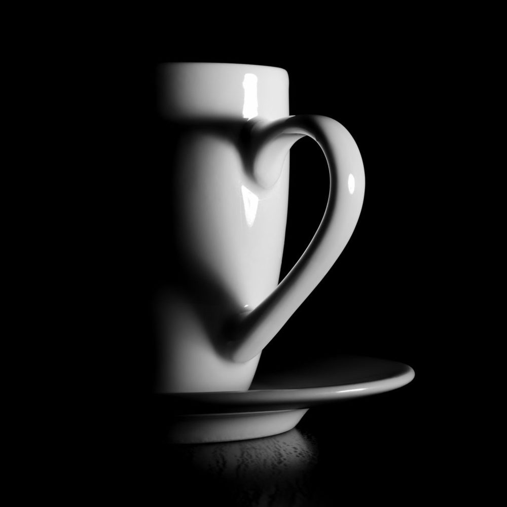 White coffee cup with shadow from handle in heart form